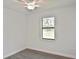 Bedroom offers sleek ceiling fan, neutral paint, luxury vinyl plank flooring and abundant sunlight at 3836 Wenona Dr, North Port, FL 34288