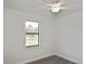 This bright bedroom features a modern ceiling fan, luxury vinyl plank floors, and bright natural light at 3836 Wenona Dr, North Port, FL 34288