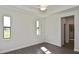 Bright bedroom features ample natural light and stylish gray wood-look flooring at 3836 Wenona Dr, North Port, FL 34288