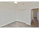 Well-lit bedroom with double closet doors, ceiling fan, and hallway access at 3836 Wenona Dr, North Port, FL 34288