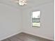 Bedroom offers sleek ceiling fan, neutral paint, luxury vinyl plank flooring and abundant sunlight at 3836 Wenona Dr, North Port, FL 34288