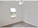 A clean bedroom features modern ceiling fan, luxury vinyl plank floors, and bright natural light at 3836 Wenona Dr, North Port, FL 34288