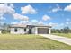 Charming single-story home with a well-manicured lawn and a two-car garage at 3836 Wenona Dr, North Port, FL 34288