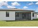 Rear exterior view of home and its screened-in porch that offers great outdoor entertaining opportunities at 3836 Wenona Dr, North Port, FL 34288