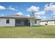 The home's rear exterior view, including a screened-in porch and an adjacent building at 3836 Wenona Dr, North Port, FL 34288