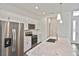 New kitchen featuring stainless steel appliances, white cabinets, and a marble countertop island at 3836 Wenona Dr, North Port, FL 34288