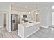 Modern kitchen features a center island with stainless steel appliances at 3836 Wenona Dr, North Port, FL 34288