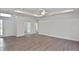 Open living room features high ceilings and sleek wood-look flooring at 3836 Wenona Dr, North Port, FL 34288