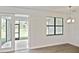 Bright living room with modern lighting and a sliding glass door to the patio at 3836 Wenona Dr, North Port, FL 34288