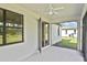 Covered patio with ceiling fan, screen enclosure and view of landscaped backyard at 3836 Wenona Dr, North Port, FL 34288