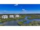 Aerial view showcasing the community's prime waterfront location, with lush greenery and pristine waters at 385 N Point Rd # 903, Osprey, FL 34229