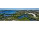 Stunning aerial view of waterfront property with lush greenery and clear blue waters at 385 N Point Rd # 903, Osprey, FL 34229