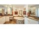 Bathroom featuring dual sinks, marble counters, and a large soaking tub at 385 N Point Rd # 903, Osprey, FL 34229