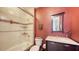 Red-themed bathroom with shower and bathtub enclosed behind glass doors at 385 N Point Rd # 903, Osprey, FL 34229