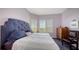 Cozy bedroom with large bed and wooden shutters with picturesque nature views at 385 N Point Rd # 903, Osprey, FL 34229
