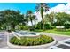 Community entrance with decorative fountain and landscaped grounds at 385 N Point Rd # 903, Osprey, FL 34229