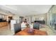 Open floor plan with dining and living area, tiled floors and modern design, great natural light, and a view of the balcony at 385 N Point Rd # 903, Osprey, FL 34229
