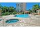 Community pool area with hot tub and multiple lounge chairs and shade structures at 385 N Point Rd # 903, Osprey, FL 34229