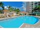 Beautiful community pool area with ample seating and lush tropical landscaping at 385 N Point Rd # 903, Osprey, FL 34229