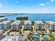 Aerial view of colorful condo buildings and pool overlooking a bay and bridge at 388 Aruba Cir # 103, Bradenton, FL 34209