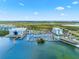 Aerial view of a marina with boat docks and waterways, near coastal buildings and lush greenery at 388 Aruba Cir # 103, Bradenton, FL 34209