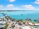 Picturesque aerial view of clear turquoise ocean and the shore with beach restaurants at 388 Aruba Cir # 103, Bradenton, FL 34209