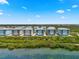 Beautiful aerial view of waterfront condo buildings with scenic water and lush vegetation at 388 Aruba Cir # 103, Bradenton, FL 34209