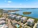 Wide aerial view of condos, pool, island, waterways, roads and bridge at 388 Aruba Cir # 103, Bradenton, FL 34209
