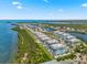 Stunning aerial view of a community with waterfront condos, green spaces, and access to beautiful water views at 388 Aruba Cir # 103, Bradenton, FL 34209