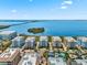 Wide aerial view of condos, pool, island, waterways and distant bridge at 388 Aruba Cir # 103, Bradenton, FL 34209