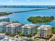 Picturesque aerial view of waterfront condos and long bridge over blue waters at 388 Aruba Cir # 103, Bradenton, FL 34209