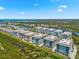 Aerial view of several condos in a waterfront community with green landscape at 388 Aruba Cir # 103, Bradenton, FL 34209