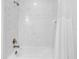 Bathroom with white tile tub-shower and bronze hardware with shower curtain at 388 Aruba Cir # 103, Bradenton, FL 34209