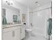 Bright bathroom offers a granite countertop vanity and a tub-shower combo with marble style tile at 388 Aruba Cir # 103, Bradenton, FL 34209