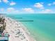 Beautiful beach scene with turquoise water, piers, and beachgoers enjoying the sunny day at 388 Aruba Cir # 103, Bradenton, FL 34209
