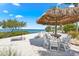 Beachfront Tiki Hut featuring chairs, tables, and stunning views at 388 Aruba Cir # 103, Bradenton, FL 34209