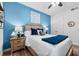 This bedroom features wood-look floors, two bedside tables and is decorated with blue accents at 388 Aruba Cir # 103, Bradenton, FL 34209