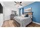 Bedroom with wood-look floors, blue accent wall, and coordinated decor creates a peaceful and inviting space at 388 Aruba Cir # 103, Bradenton, FL 34209