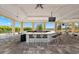 Clubhouse outdoor bar area with bar top and TV at 388 Aruba Cir # 103, Bradenton, FL 34209