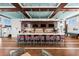 Clubhouse bar with TVs, countertop seating, and decorative backsplash at 388 Aruba Cir # 103, Bradenton, FL 34209