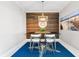Chic dining space featuring a wood accent wall, nautical rug, and beachy decor at 388 Aruba Cir # 103, Bradenton, FL 34209