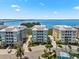 Three condos painted grey, blue, and yellow with tropical trees and paver drives at 388 Aruba Cir # 103, Bradenton, FL 34209