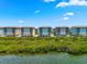 Condo buildings with serene waterfront view surrounded by lush greenery at 388 Aruba Cir # 103, Bradenton, FL 34209