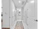 Hallway with white trim, and marble-look floors, providing access to the bedroom and bathroom at 388 Aruba Cir # 103, Bradenton, FL 34209
