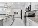 Bright kitchen with white cabinets, stainless steel appliances, granite countertops, and recessed lighting fixtures at 388 Aruba Cir # 103, Bradenton, FL 34209
