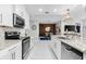 Stylish kitchen with stainless steel appliances, granite countertops, white cabinets, and recessed lighting fixtures at 388 Aruba Cir # 103, Bradenton, FL 34209