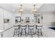Modern kitchen featuring a granite island with seating, pendant lighting, and stainless steel appliances at 388 Aruba Cir # 103, Bradenton, FL 34209
