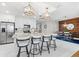 Open kitchen featuring an island with seating, stainless appliances, and adjacent dining area at 388 Aruba Cir # 103, Bradenton, FL 34209