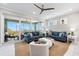 Bright living room with sliding glass doors to a balcony, comfortable couches and water view at 388 Aruba Cir # 103, Bradenton, FL 34209