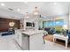 Spacious open-concept living area with island kitchen, modern finishes, and floor-to-ceiling doors to a balcony at 388 Aruba Cir # 103, Bradenton, FL 34209